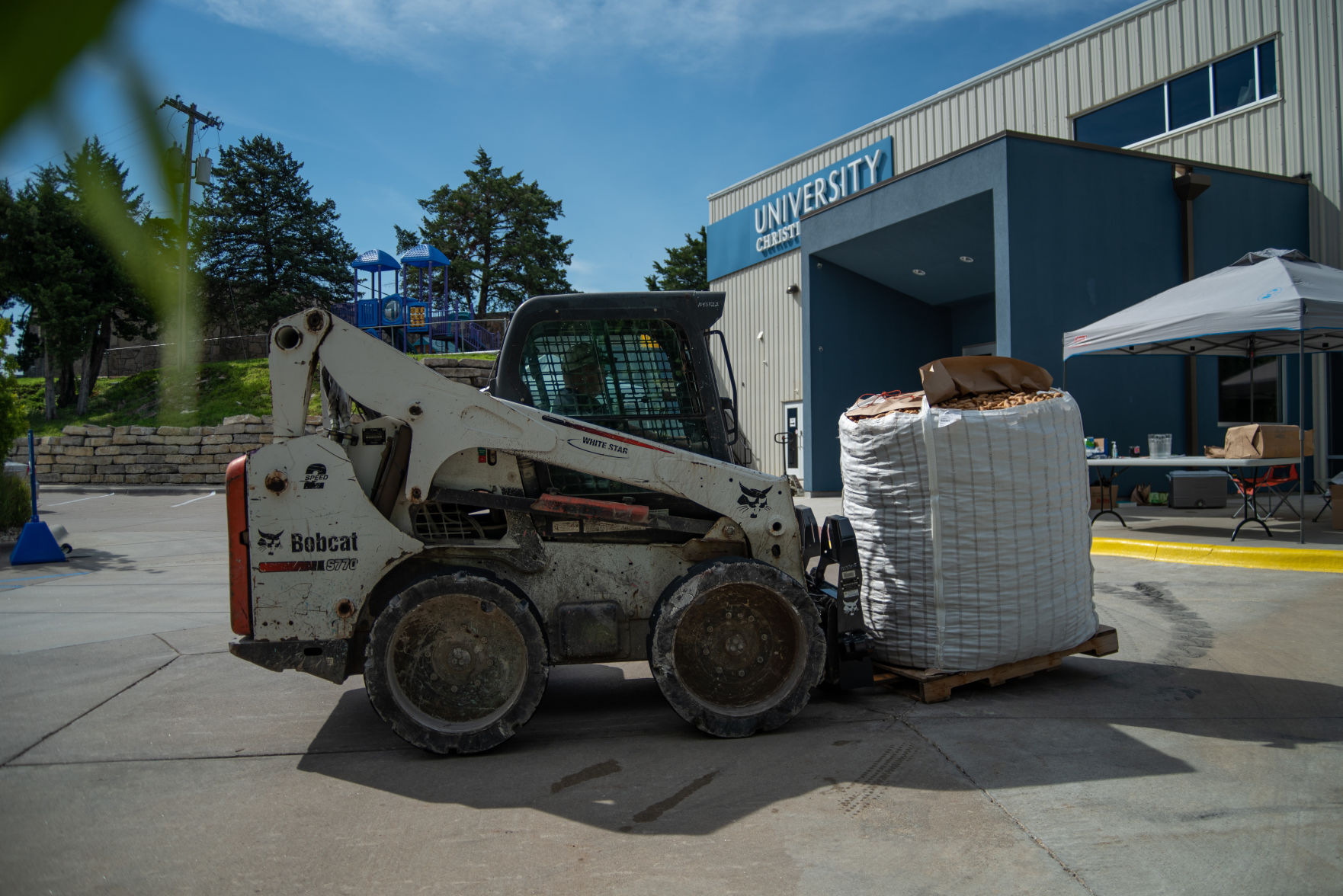 A forklift drops off a pallet of potatoes at University Christian Church on Saturday.